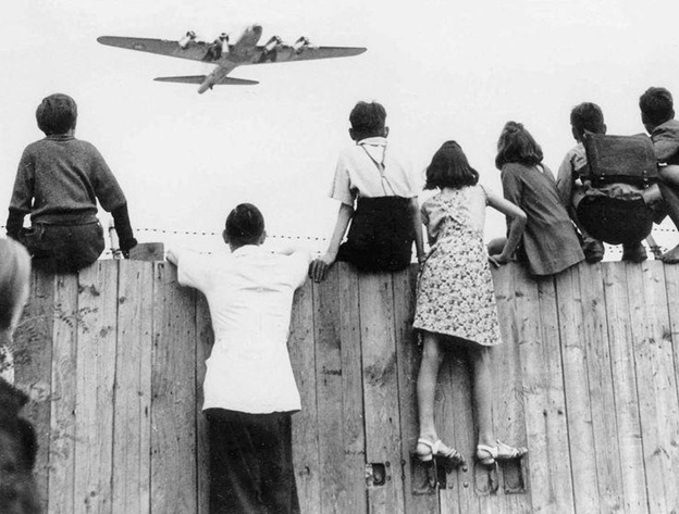 citizens of Berlin on fence watching aircraft 