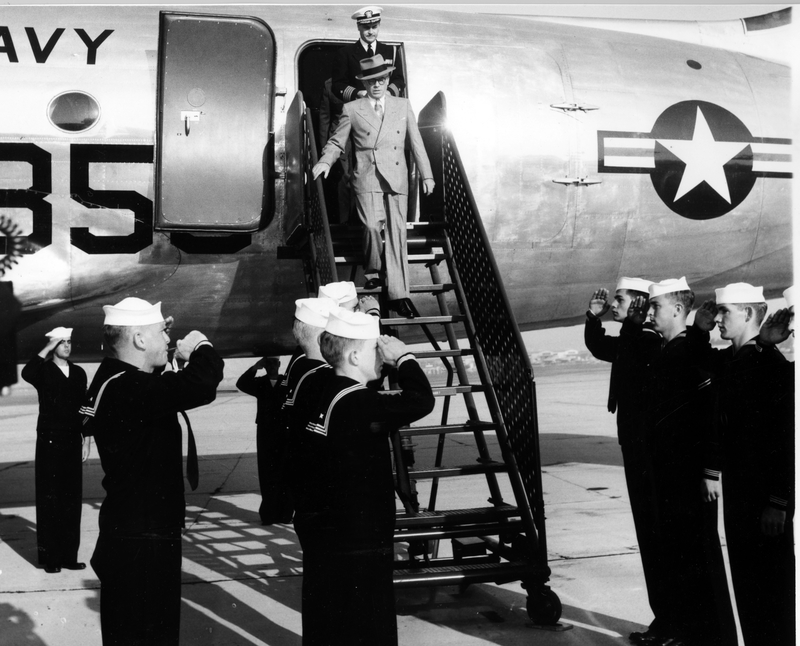 Naval personnel salute as navy under secretary francis p whitehair