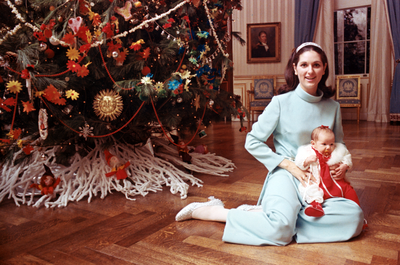 Lynda Bird Johnson Robb in front of White House Christmas tree with