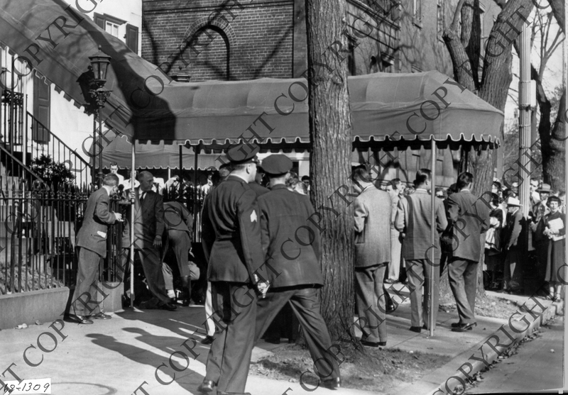 Police and spectators around entrance to blair house after