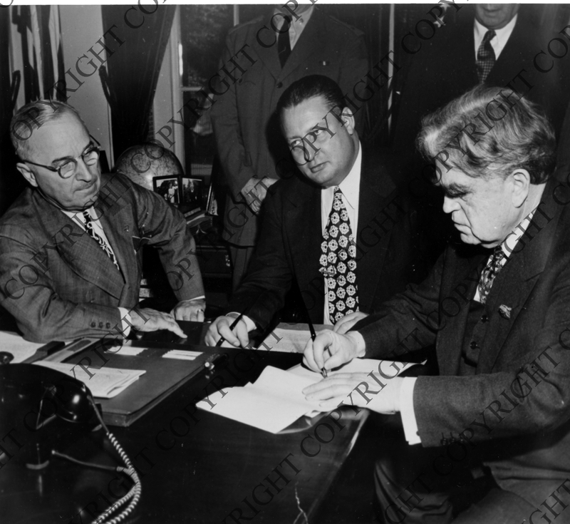 Photo showing John L. Lewis Signing a New Work Contract, with Truman