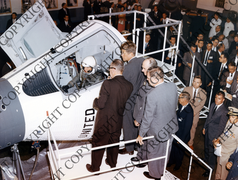 President Kennedy and others examining space capsule Harry S. Truman