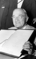 Truman signing North Atlantic Treaty document, July 25, 1949.