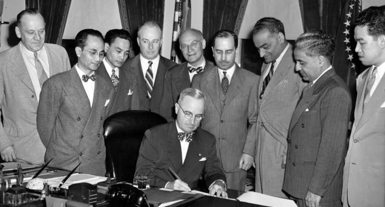 Harry Truman signing papers
