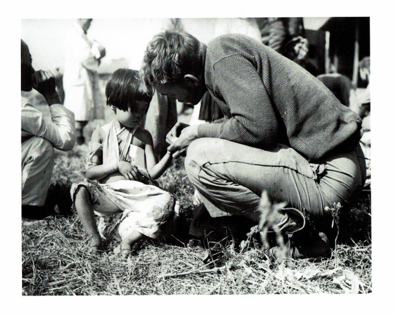 Corporal Donald Franks tells a Korean girl not to worry about her wounded arm. It will soon heal, September 29, 1950.