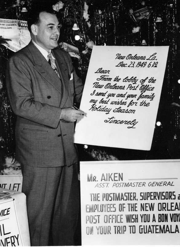 Assistant Postmaster General Paul C. Aiken with a Sign from the New