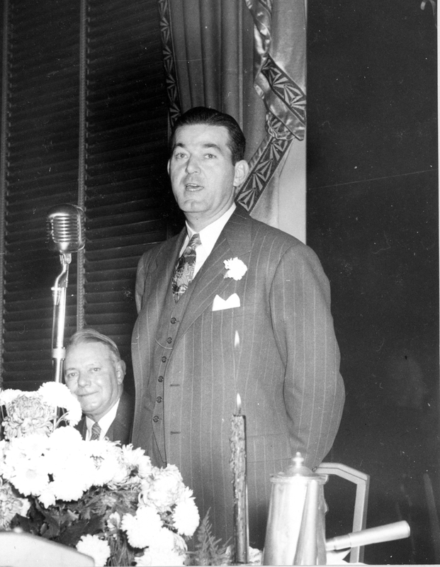 Robert E. Hannegan addressing attendees during a dinner honoring him as